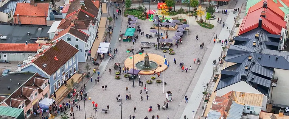 Drönarvy över Stora torget. I mitten syns Malta Johanna, runtomkring promenerar människor.